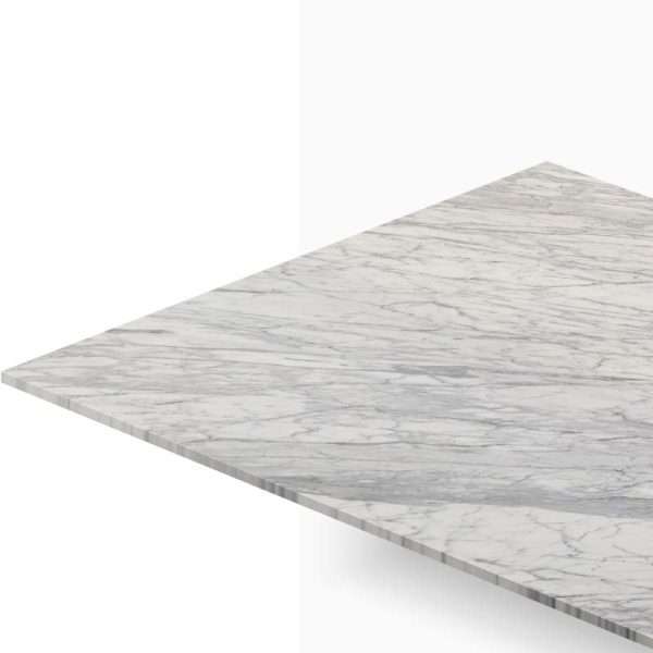 Close-up of a marble countertop with gray veining seen from an angled perspective, edge visible at the bottom left.