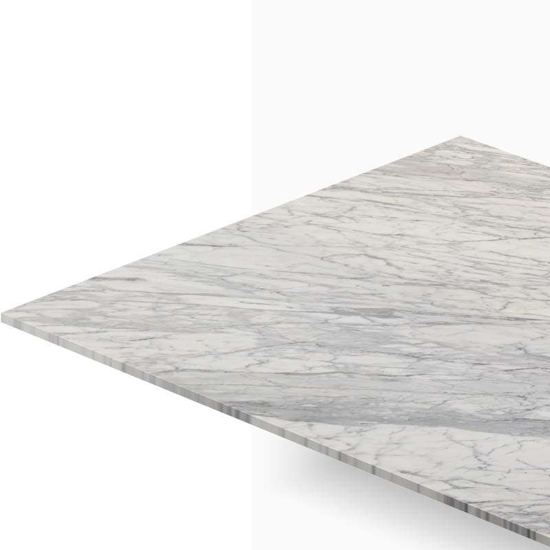 Close-up of a marble countertop with gray veining seen from an angled perspective, edge visible at the bottom left.