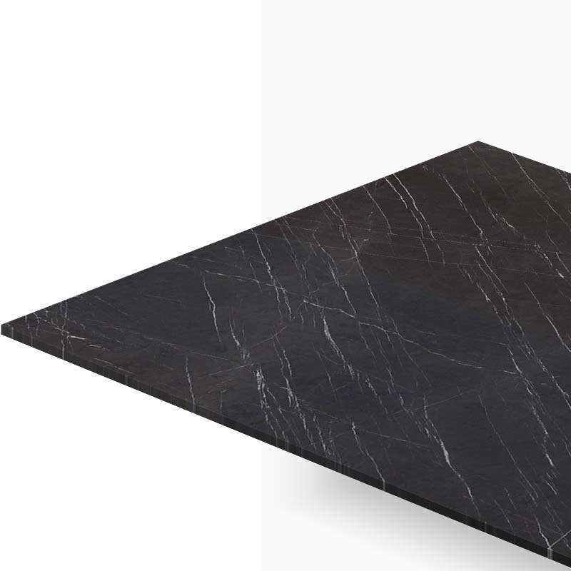 Diagonal view of a black marble tabletop with white veins, extending toward the left edge of the image.