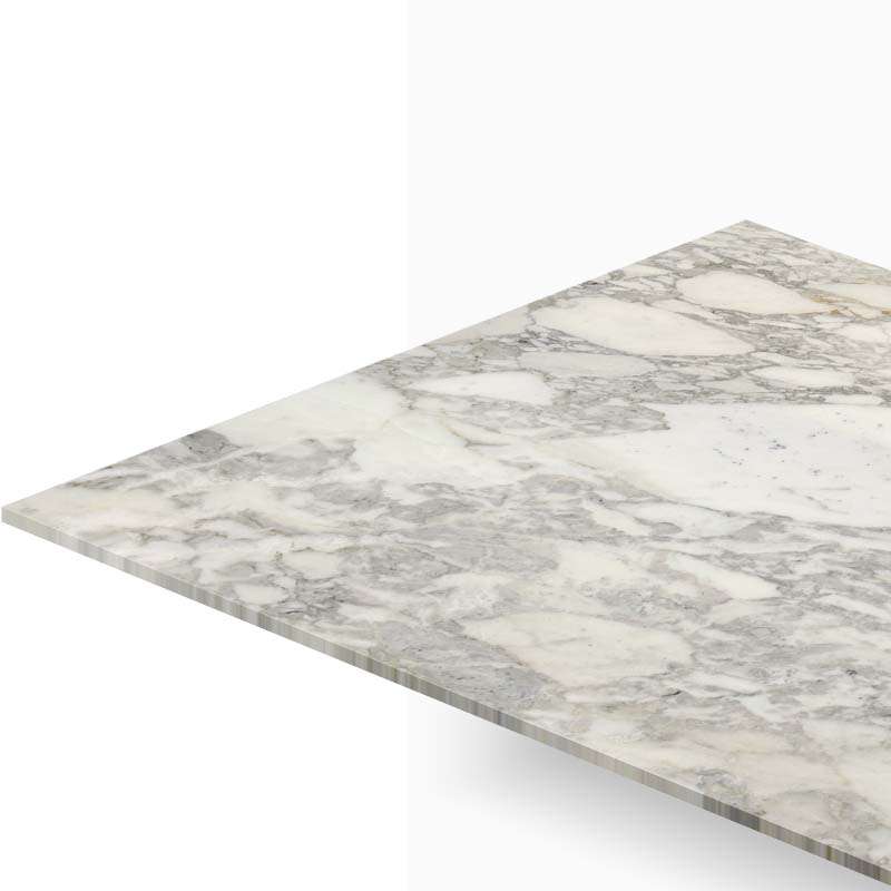 Angle view of a white marble countertop with gray veining extending toward the background