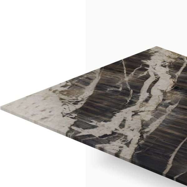 Close-up of a dark marble tabletop with bold white veins, viewed from an angled perspective.