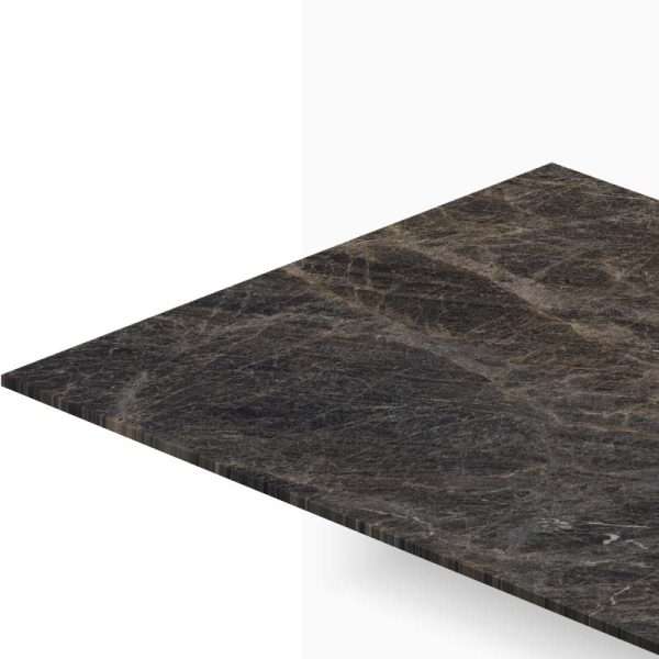 Dark marble tabletop viewed from a corner with a beveled edge, showing its veined texture and glossy surface.