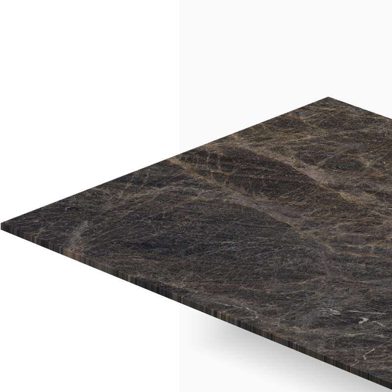 Dark marble tabletop viewed from a corner with a beveled edge, showing its veined texture and glossy surface.