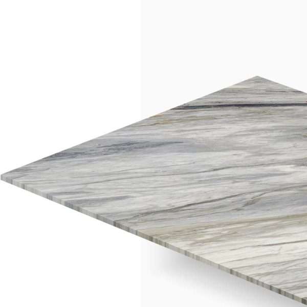 Close-up view of a marble tabletop edge with gray veining, seen from a corner against a white background.