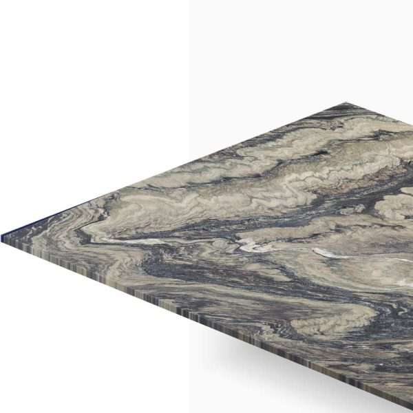 Close-up of a marble-patterned tabletop edge viewed at an angle, showing grey-beige swirls and a sharp corner.
