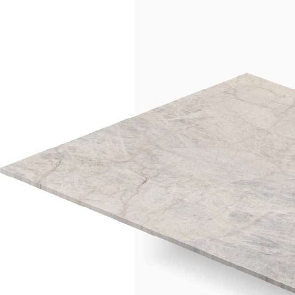 Angled view of a light gray marble countertop surface with subtle veining and an exposed edge.