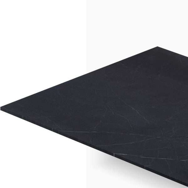 Close-up of a dark marble tabletop angled across a white background, showing subtle veining and edge detail.