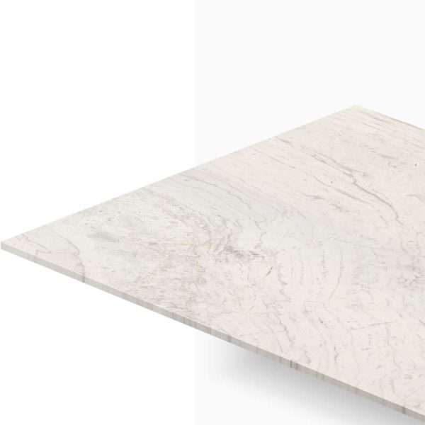 Corner view of a light marble countertop with subtle gray veining and visible edge detail