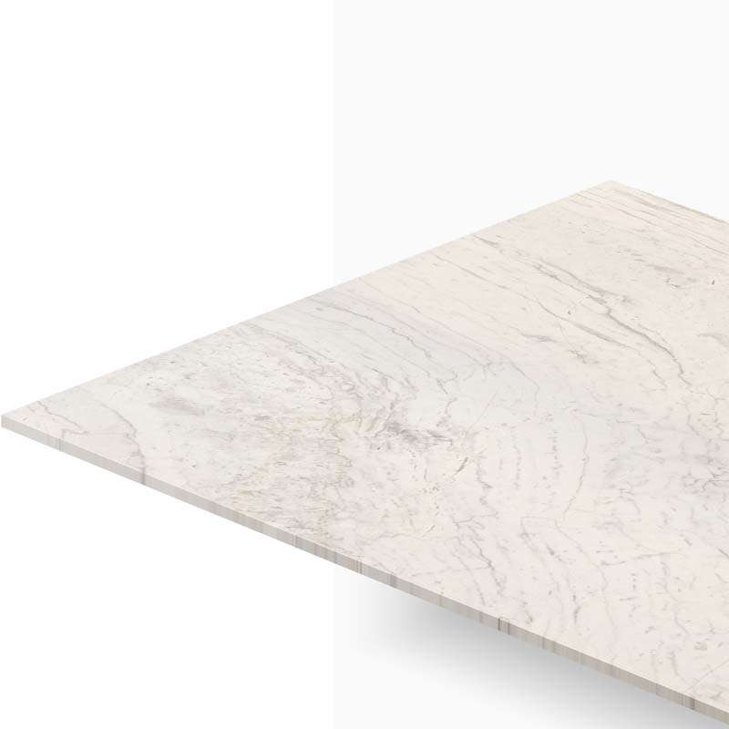 Corner view of a light marble countertop with subtle gray veining and visible edge detail